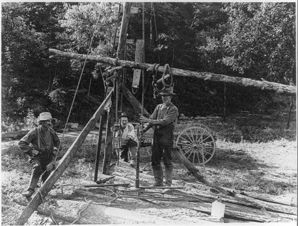 Vintage photo of men digging a well by hand