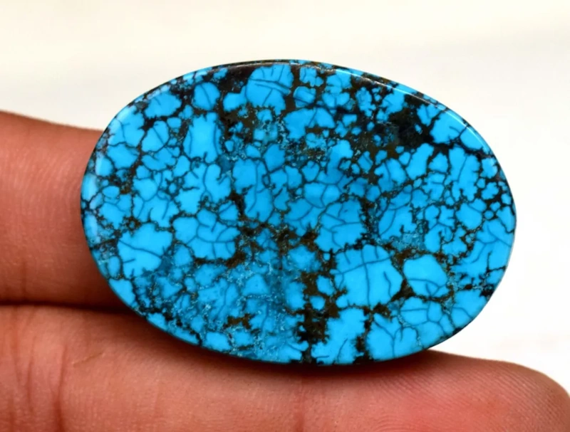 cabachon of bisbee turquoise with bright blue coloration